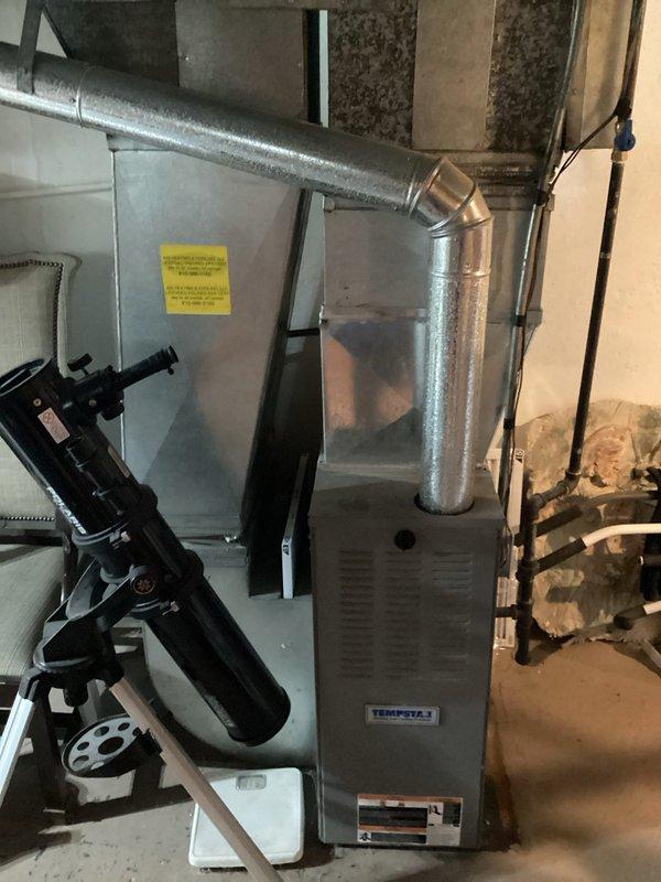 Completed air conditioning replacement estimate for customer at scheduled afternoon appointment. Assessed existing Tempstar furnace and HVAC system located in basement utility area, evaluated current ductwork configuration including horizontal and vertical metallic runs with elbow transitions, and documented equipment conditions through photographs to provide comprehensive replacement recommendations.
