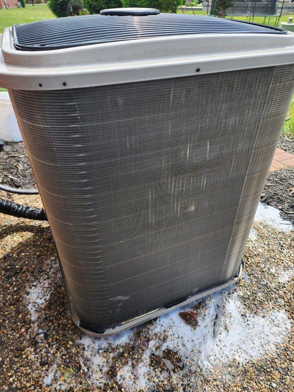 # Annual Cooling System Maintenance

Performed comprehensive annual maintenance on residential air conditioning system. Unit was operational upon arrival with no reported issues. Conducted complete inspection of outdoor condenser unit, which is positioned on gravel pad in good overall condition showing normal weathering. Examined heat exchanger coils with bronze-colored fins arranged in vertical rows - coils appear functional with typical outdoor aging present.

Inspected internal components including condensate drain pan showing normal wear and discoloration consistent with regular use. Evaluated refrigerant lines of varying diameters with characteristic copper patina. Noted black foam insulation on copper piping sections with some deterioration present - typical for systems of this age. All refrigerant lines properly routed and secured.

Verified electrical connections and conduit routing. Checked system operation and confirmed proper cooling function. System performing within normal