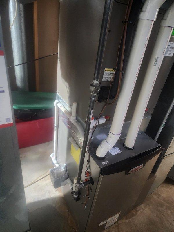 Completed warranty service to address electrical code violations identified during inspection of newly installed HVAC system in basement utility area. Installed GFCI protection for receptacle serving furnace in unfinished space per MRC E3902.5 and NEC 210.8(A)(5) requirements. Added protective bushing to conduit termination where NM cable enters to prevent conductor damage, ensuring compliance with NEC 334.15(B) specifications.