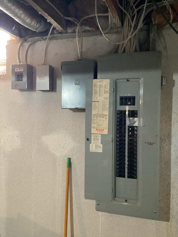 Conducted comprehensive HVAC system replacement estimate at residential property. Evaluated existing electrical infrastructure including outdoor disconnect box with dual circuit breakers and main electrical panel in basement utility area. Documented current equipment configuration, electrical service capacity, conduit routing, and panel accessibility for proposed system installation. Photographed all relevant components to support equipment sizing recommendations and replacement scope development.