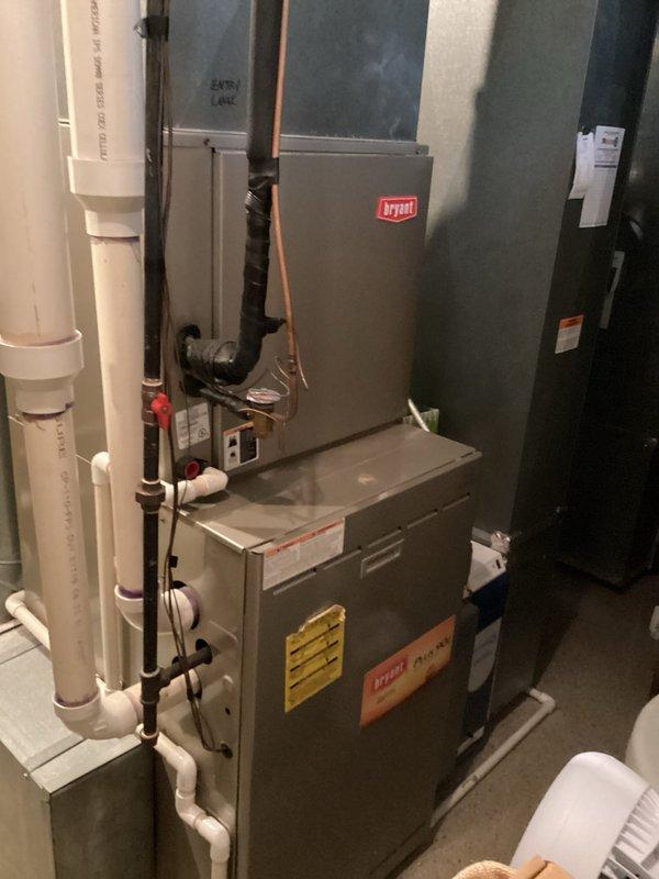 Provided comprehensive estimate for complete replacement of two full HVAC systems serving the residence. Existing equipment includes 20-year-old Bryant furnace and air conditioning system currently operational but at end of expected service life. Assessed basement mechanical room installation including furnace, air handler, refrigerant lines, condensate drainage system, and associated ductwork to determine replacement specifications and requirements for new high-efficiency heating and cooling systems.