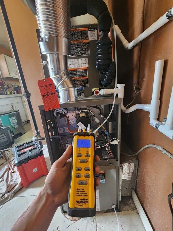 Completed full HVAC system installation including Lennox 80% efficiency gas furnace, air conditioning condenser unit, whole-home humidifier, and T6 programmable thermostat. Outdoor condenser unit was positioned on rubber isolation pad with proper clearances from structure, connected refrigerant lines, and electrical supply established. Indoor furnace installed in closet space with complete ductwork connections, PVC condensate drainage system, fresh air intake piping, and humidifier integration into supply plenum. Thermostat wired and programmed for system operation. All electrical connections completed to code, refrigerant lines pressure tested and charged to manufacturer specifications, and system startup performed with verification of proper heating and cooling operation.