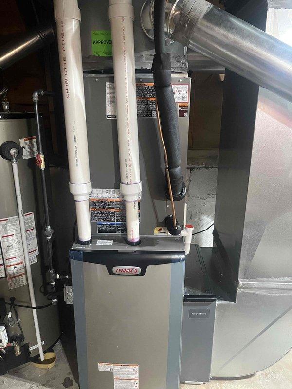Completed full HVAC system installation including Lennox furnace, air conditioning unit, whole-home humidifier, and Lennox S40 Smart Thermostat. All equipment installed to manufacturer specifications with proper venting, ductwork connections, and electrical hookups verified and operational.

Installed Lennox furnace in basement utility area with dual PVC intake and exhaust venting routed vertically through structure. Secured all vent pipes with appropriate fasteners and verified proper clearances from combustible materials. Connected supply and return ductwork using metallic flex duct with sealed joints and secure metal clamps. Verified furnace mounting stability on concrete pad and confirmed all gas line connections are leak-free.

Installed outdoor air conditioning condenser unit with proper refrigerant line connections to indoor coil. Evacuated system, charged with manufacturer-specified refrigerant quantity, and verified operating pressures within normal parameters. Tested system c