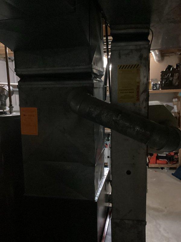 Conducted comprehensive assessment of existing HVAC system for replacement estimate. Evaluated 37-year-old air conditioning unit located outside and 11-year-old furnace system in basement. Both systems currently operational but nearing end of service life. Documented equipment specifications, ductwork conditions including visible rust deterioration on vertical duct sections, and overall system configuration. Photographed existing furnace unit, associated ductwork, copper piping, and gas line connections to provide accurate replacement specifications and identify any necessary modifications for new equipment installation.