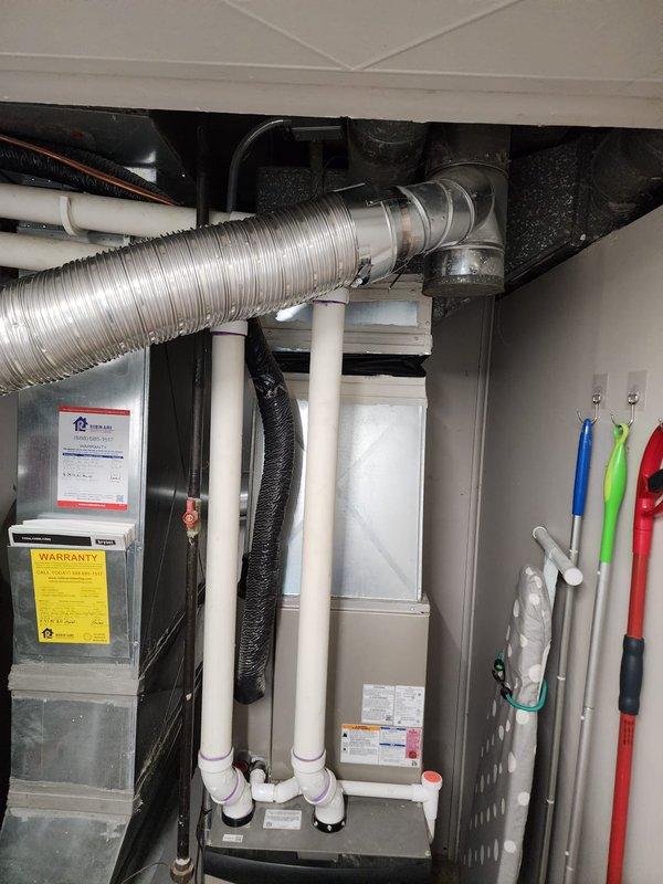 Installed Bradford White tanked water heater in residential utility closet, including all necessary copper supply line connections with shut-off valves, proper venting configuration, and blue expansion tank mounted to ceiling structure. All plumbing connections were completed to code specifications, with the unit positioned for optimal access alongside existing HVAC equipment, ensuring proper clearances and integration with existing PVC drainage and ventilation systems.