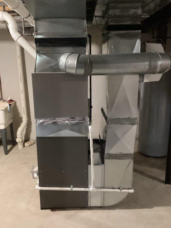 Provided estimate for complete air conditioning system replacement in residential basement mechanical room. Existing AC unit over 16 years old was non-operational and required full system replacement. Assessment included evaluation of existing gray metal air handler unit, ductwork connections, refrigerant lines, condensate drainage system, and electrical connections to determine proper replacement specifications and installation requirements.
