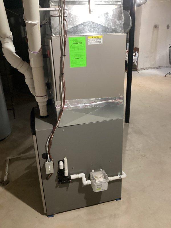 Provided estimate for complete air conditioning system replacement in residential basement mechanical room. Existing AC unit over 16 years old was non-operational and required full system replacement. Assessment included evaluation of existing gray metal air handler unit, ductwork connections, refrigerant lines, condensate drainage system, and electrical connections to determine proper replacement specifications and installation requirements.