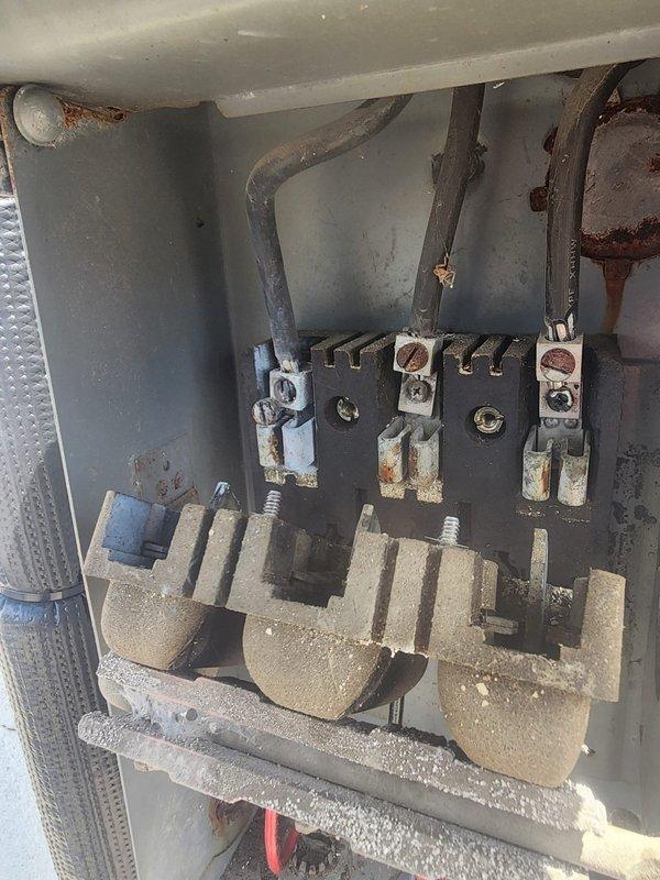 Responded to callback for non-operational air conditioning system. Upon arrival, performed diagnostic testing and discovered severe corrosion and oxidation on electrical disconnect panel terminals and fuse blocks, indicating prolonged exposure to outdoor elements. Measured system temperatures and pressures using digital gauges to verify refrigerant levels and operational parameters. Inspected electrical connections and found compromised contacts due to rust buildup on metal components and mounting hardware. Cleaned corroded terminals, tightened all electrical connections, and verified proper voltage supply to outdoor condensing unit. System restored to normal operation with proper temperature differential readings confirmed on diagnostic equipment.