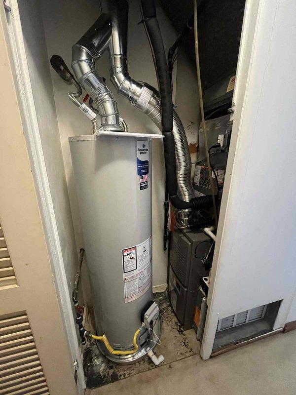 Completed full HVAC system installation in interior closet space, including Lennox 80% efficiency gas furnace, central air conditioning system, Lennox T6 programmable thermostat, and 40-gallon residential gas water heater. Configured all metal vent piping for proper exhaust routing through ceiling structure, installed yellow gas line connections to both furnace and water heater per code requirements, and established complete ductwork integration for heating and cooling distribution. Verified all electrical connections, tested thermostat communication with HVAC equipment, confirmed proper condensate drainage routing to exterior discharge point, and ensured all units achieved full operational status with appropriate airflow and temperature differentials.