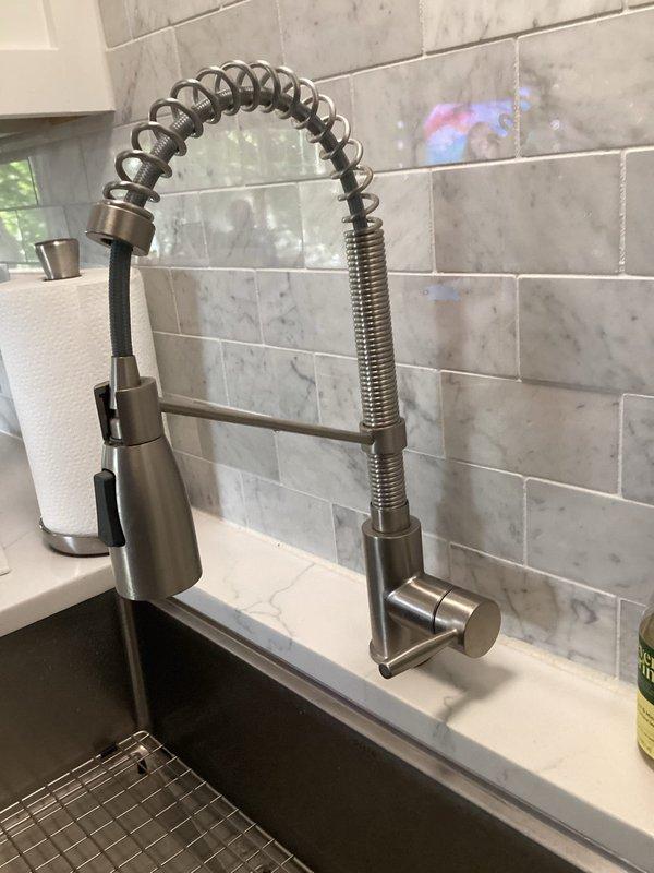 Responded to callback for kitchen sink faucet with no hot water following initial installation. Upon inspection, verified hot water was available at other fixtures throughout the home. Diagnosed and corrected supply line connection issue at the newly installed commercial-style pull-down faucet, restoring proper hot water flow to the kitchen sink and confirming full functionality of the fixture.