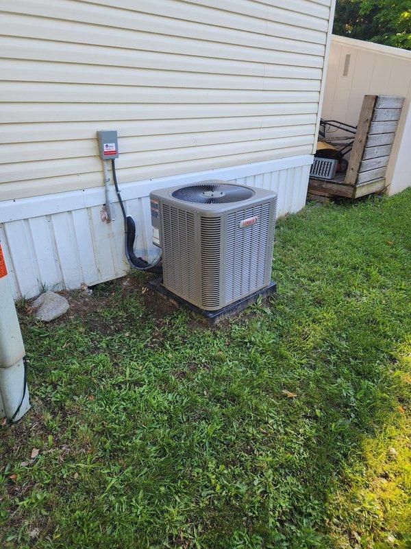 Completed warranty work on exterior lineset penetration at residential HVAC installation. Properly insulated exposed refrigerant lines and sealed wall entry point where conduit enters building to prevent air infiltration and protect against weather exposure. Documented completed repairs with photographs showing Bryant condenser unit and sealed penetration points with protective boot installed at siding junction.