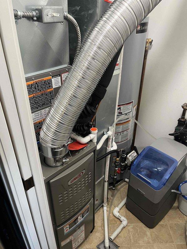 Successfully completed full HVAC system installation in residential utility closet, including new Lennox 80% efficiency furnace, air conditioning system, and T6 programmable thermostat. Replaced existing humidifier pad as part of the installation process. All equipment properly positioned, connected to existing ductwork with flexible aluminum ducting, and integrated with electrical and plumbing systems including condensate drainage lines. System tested and verified operational upon completion.