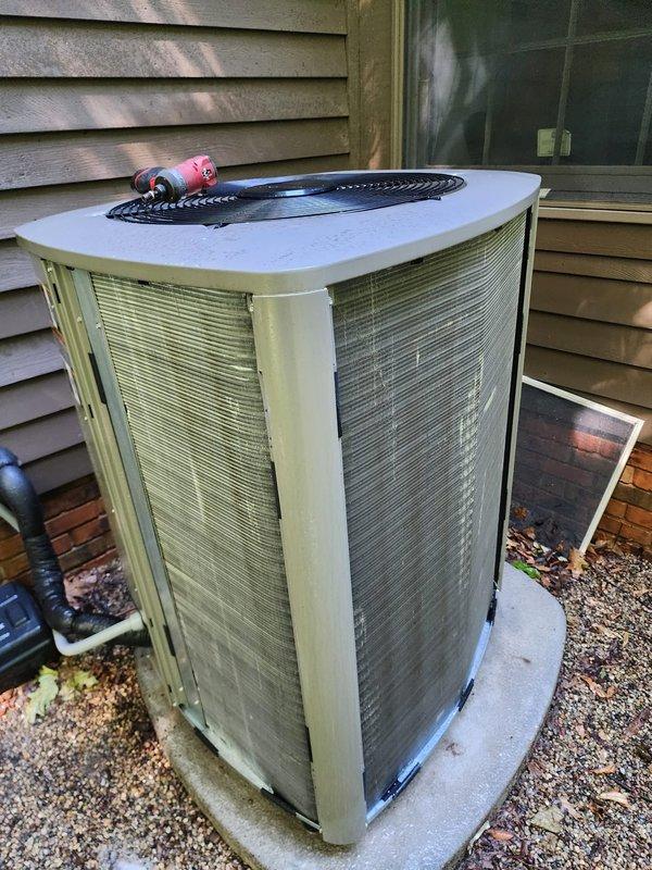 Completed scheduled air conditioning maintenance service on residential split system. Performed comprehensive inspection of outdoor condenser unit and indoor air handler located in attic space. Outdoor unit found in operational condition with proper airflow through coil fins and fan assembly. Indoor air handler inspected with attention to drain pan showing signs of normal condensation accumulation and rust staining consistent with system age. Verified refrigerant lines and connections for proper insulation and secure fittings. System tested and confirmed cooling operation within normal parameters.