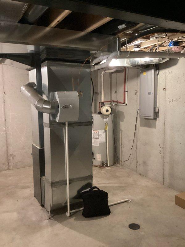 Completed estimate for air conditioning system replacement on existing HVAC installation in basement mechanical room. Current AC unit is operational but nearing end of service life based on previous repair technician recommendation. Evaluated existing furnace, ductwork configuration, refrigerant line routing with purple insulation, and PVC venting system to determine compatibility requirements for new equipment. Documented current system specifications including air handler setup, electrical connections, and clearance dimensions for replacement unit sizing. Provided homeowner with comprehensive replacement options and discussed potential to apply previous repair costs toward new system installation.