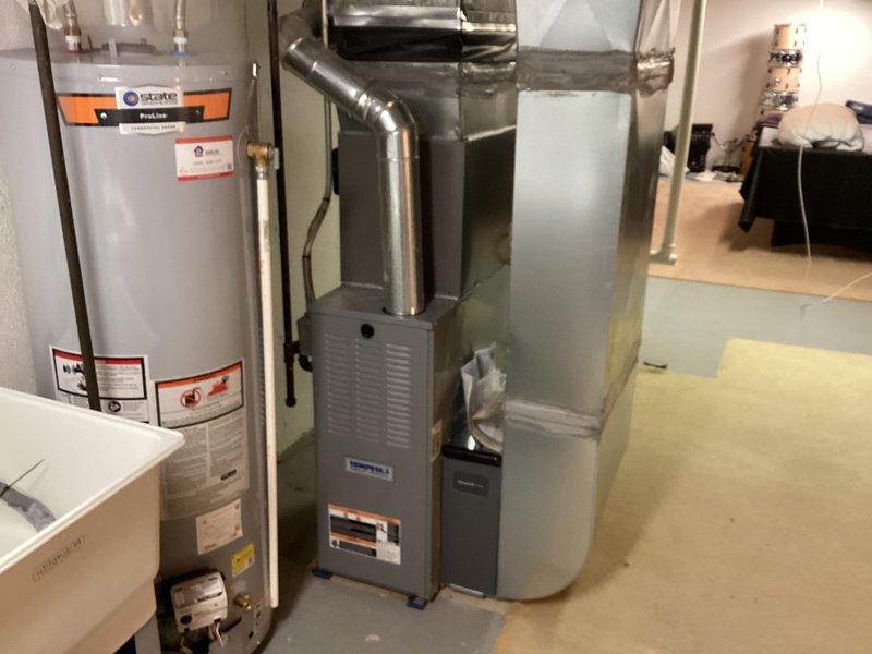 Completed installation of new Lennox air conditioning system in residential basement mechanical room. Unit was properly connected to existing furnace and ductwork, with all electrical and refrigerant lines installed per manufacturer specifications and local code requirements.