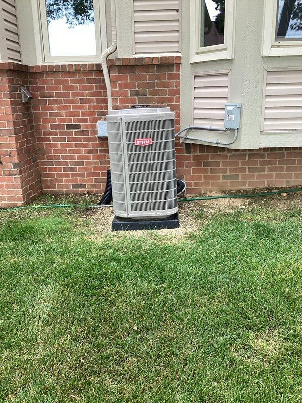 Responded to service request to reposition outdoor condensing unit that had shifted off-center on equipment pad. Upon arrival, accessed backyard via swale between properties and confirmed condenser was positioned significantly to the left side of the black plastic base pad. Carefully repositioned the unit to center it properly on the pad, ensuring adequate clearance from house exterior and proper alignment with refrigerant lines and electrical connections. Verified unit stability and confirmed all connections remained secure with no stress on refrigerant lines or electrical conduit. Unit now properly centered on pad with appropriate clearances maintained for optimal airflow and serviceability.