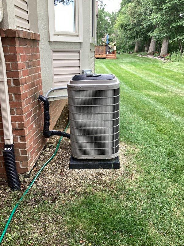 Responded to service request to reposition outdoor condensing unit that had shifted off-center on equipment pad. Upon arrival, accessed backyard via swale between properties and confirmed condenser was positioned significantly to the left side of the black plastic base pad. Carefully repositioned the unit to center it properly on the pad, ensuring adequate clearance from house exterior and proper alignment with refrigerant lines and electrical connections. Verified unit stability and confirmed all connections remained secure with no stress on refrigerant lines or electrical conduit. Unit now properly centered on pad with appropriate clearances maintained for optimal airflow and serviceability.