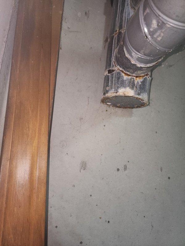 Responded to complaint of intermittent furnace noise. Upon inspection, identified severely corroded and deteriorated ductwork connection at elbow joint near furnace. The galvanized metal duct showed significant rust and structural degradation at the connection point, which was likely causing vibration and noise during blower operation. Documented conditions with photos for customer records.