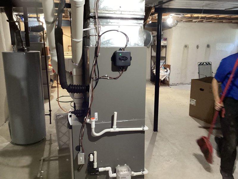 Completed installation of Lennox air conditioning system in residential basement location. Installed new air handler unit with proper refrigerant line connections, secured PVC condensate drainage piping with appropriate fasteners, and verified all electrical connections and system controls are functioning correctly.