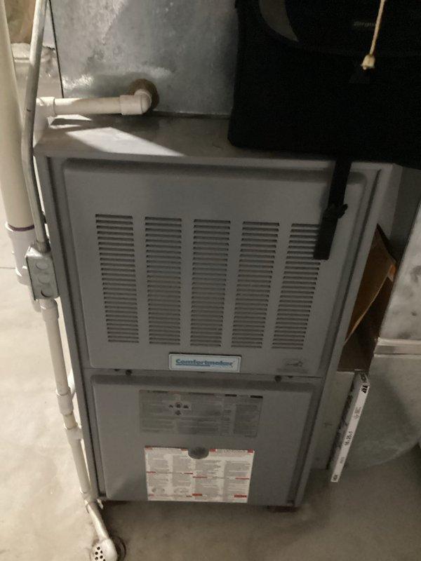 Conducted comprehensive on-site evaluation for complete HVAC system replacement at residential property. Assessed existing Comfortmaker furnace installation in basement utility area, documenting current equipment configuration, PVC condensate drainage system, ductwork connections, and overall mechanical room layout. Photographed equipment specifications, clearances, and existing infrastructure to develop accurate replacement proposal and ensure proper system sizing for new installation.