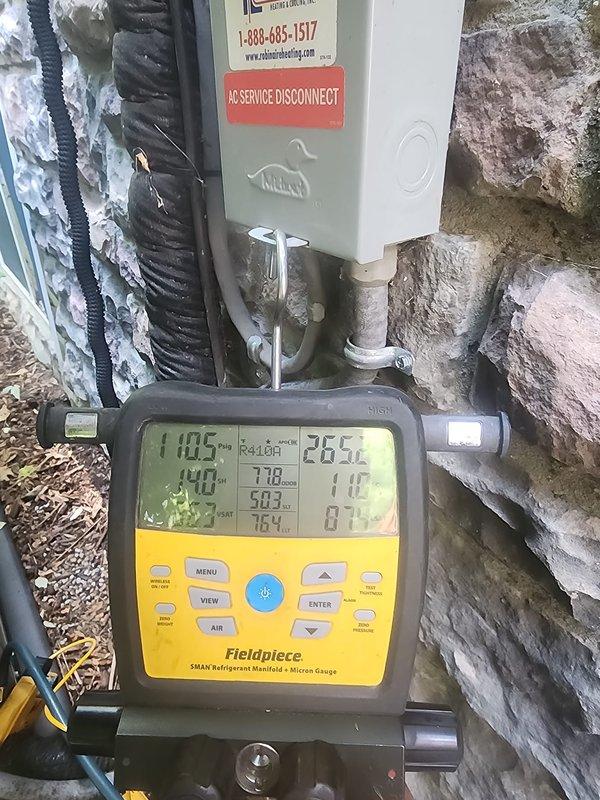 Completed scheduled AC maintenance on Bryant air conditioning system. Connected refrigerant manifold gauges to outdoor unit and recorded system operating pressures and temperatures, with readings showing 110.5°F on high side and 28.5°F on low side. Inspected indoor evaporator coil and found light dust accumulation on vertical fins; coil remains in serviceable condition with no significant blockage or damage noted. System operating within normal parameters at time of service.
