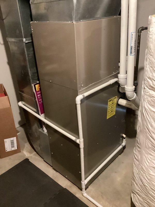Provided comprehensive estimate for full HVAC system replacement of existing 2011 equipment currently installed in basement utility area. Evaluated operational gas furnace with air handler unit, assessed existing ductwork configuration, PVC condensate drainage system, and venting infrastructure to determine replacement specifications and equipment requirements. Documented current system layout including multiple duct branches and properly routed condensate lines for accurate proposal preparation.