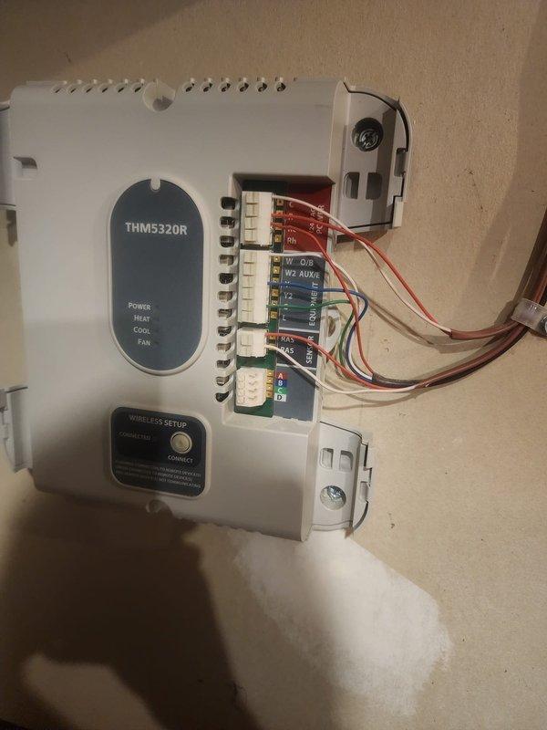 Responded to no cooling call where thermostat was calling but system was not operating. Inspected THM5320R thermostat control module and found wiring connection issues at terminal block. Verified proper wire terminations, secured loose connections, and confirmed all HVAC control wiring was properly seated in terminal points. Tested system operation and verified thermostat communication with cooling equipment, restoring normal AC function.