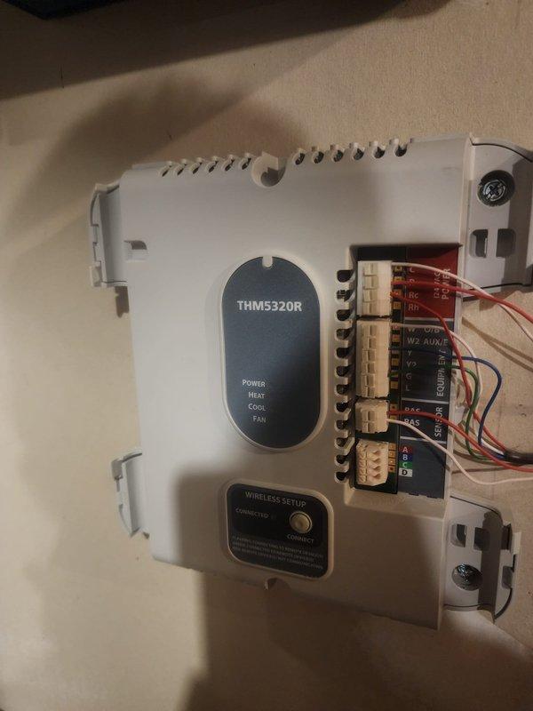 Responded to no cooling call where thermostat was calling but system was not operating. Inspected THM5320R thermostat control module and found wiring connection issues at terminal block. Verified proper wire terminations, secured loose connections, and confirmed all HVAC control wiring was properly seated in terminal points. Tested system operation and verified thermostat communication with cooling equipment, restoring normal AC function.