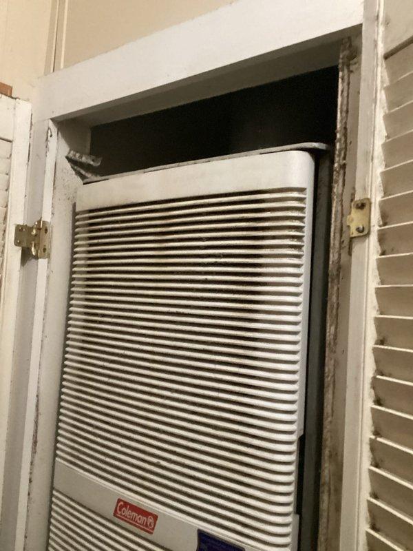 Conducted comprehensive equipment evaluation for complete HVAC system replacement estimate including air conditioning unit, furnace, and hot water heater. Existing Coleman equipment has been in service since 1997 and is currently operational but performing below optimal efficiency standards. Units are located in interior closet space with louvered door access, utilizing natural gas fuel source for heating system.
