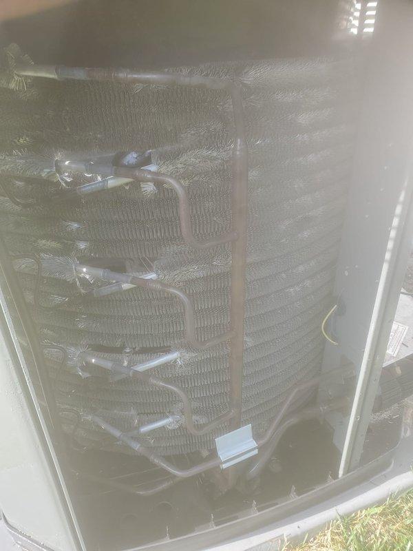 Performed comprehensive preventive maintenance on residential air conditioning system during evening service window. Conducted thorough inspection of evaporator coil assembly, verified refrigerant line connections and insulation integrity, and documented condenser unit operation with protective cover in place. All components found operating within normal parameters with appropriate condensation present on evaporator dome, indicating proper cooling cycle function.
