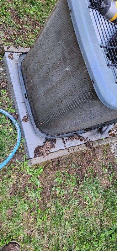 Completed scheduled prepaid maintenance tune-up on residential cooling system. Performed comprehensive inspection of outdoor condenser unit, including examination of condenser coil which showed moderate accumulation of dirt and debris between fins. Verified system operation and confirmed unit is functioning properly. Documented equipment condition with photos showing typical outdoor weathering on cabinet housing, including surface rust and paint deterioration consistent with age and exposure. Refrigerant lines and internal components inspected and found to be intact. System operational at time of departure.