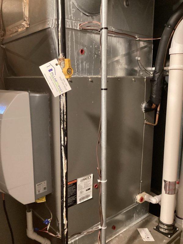 Completed HVAC system assessment for equipment replacement estimate in residential basement utility space. Evaluated existing Bryant furnace and Lennox air handler installation, documented current system configuration including ductwork plenum, condensate drain lines, refrigerant piping, and electrical connections. Photographed equipment conditions, component placement, and existing infrastructure to prepare comprehensive replacement proposal for complete system upgrade.