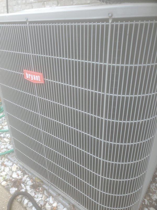 Completed scheduled maintenance on Bryant outdoor condensing unit and indoor air handler system. Performed visual inspection of exterior unit, confirming proper installation on gravel pad with adequate clearance and no visible damage to cabinet or coil fins. Inspected refrigerant line set and drainage piping for proper routing and insulation. Accessed indoor air handler components and inspected compressor assembly, copper refrigerant lines, and condensate drain pan. Noted minor discoloration and water staining in drain pan consistent with normal operation. Verified all mechanical connections secure and system operational.