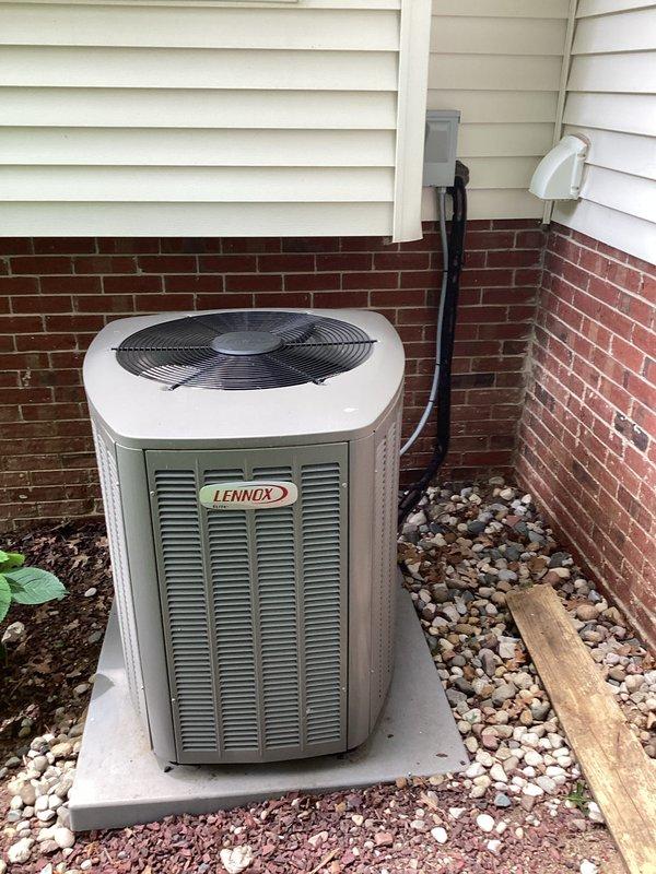 Conducted comprehensive HVAC system evaluation for replacement estimate on a 2017 Lennox outdoor condensing unit with voided warranty due to rodent damage. Documented existing equipment condition, electrical panel configuration, and installation site parameters including unit placement on concrete pad against brick and vinyl siding exterior with existing conduit routing. Provided detailed replacement recommendations and system specifications based on current installation requirements and observed conditions.