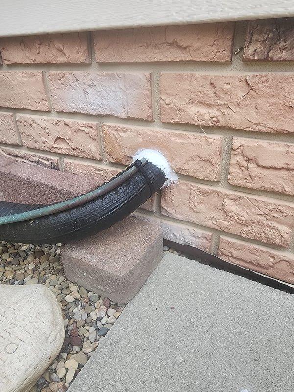 Completed warranty service on HVAC installation addressing three critical items. Sealed line set penetration at exterior skirting with appropriate foam insulation to prevent air infiltration and maintain building envelope integrity. Rerouted gas supply line to furnace to eliminate interference with blower motor access and ensure proper serviceability of equipment. Replaced gas connectors with code-compliant, labeled connectors per current safety standards, as existing connectors cannot be reused per code requirements. Verified furnace filter condition and documented all completed work with photographic evidence per warranty protocol.