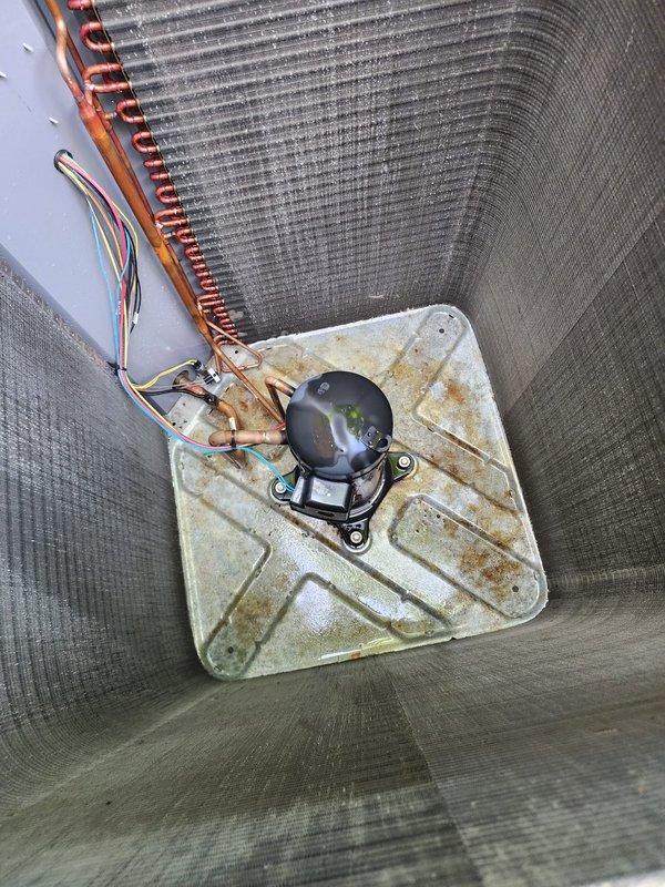 Completed preventative maintenance inspection on residential split system air conditioning unit per Worry Free Service Agreement. Inspected indoor evaporator coil assembly and condensate drain pan, noting rust staining and discoloration on pan surface; verified condensate pump operation and electrical connections. Performed exterior inspection of condenser unit, checking refrigerant line connections and overall unit condition with normal weathering observed.