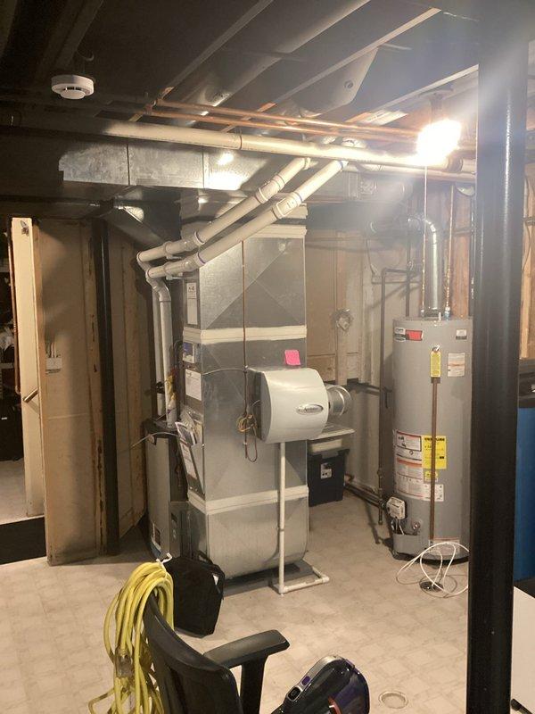 Completed comprehensive assessment of existing HVAC system and water heater in basement mechanical room for equipment replacement estimate. Documented current furnace configuration, ductwork layout, and clearances for new system installation planning. Evaluated existing utility connections including gas lines, electrical service, condensate drainage, and venting requirements to ensure compatibility with proposed replacement equipment.