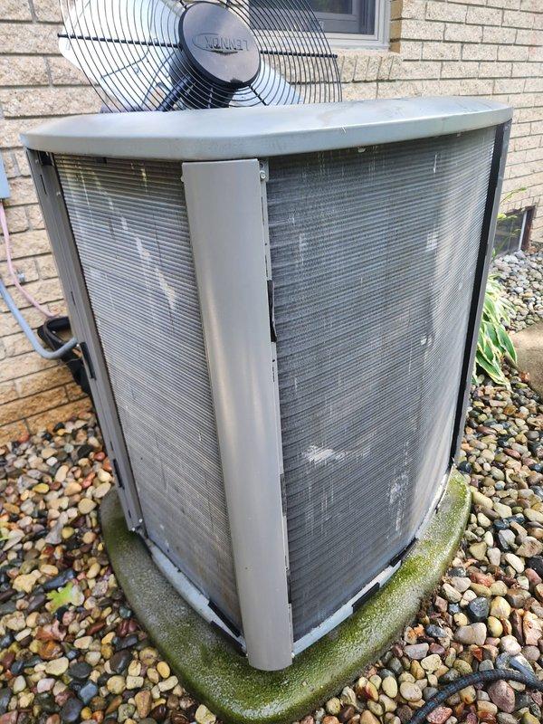 Completed comprehensive AC tune-up on 10-year-old outdoor condensing unit. Performed thorough cleaning of condenser coils, inspected compressor and fan motor operation, verified electrical connections, and cleared debris from unit exterior and surrounding area. All components operating within normal parameters; drain pan shows age-appropriate wear with minor staining but remains functional.