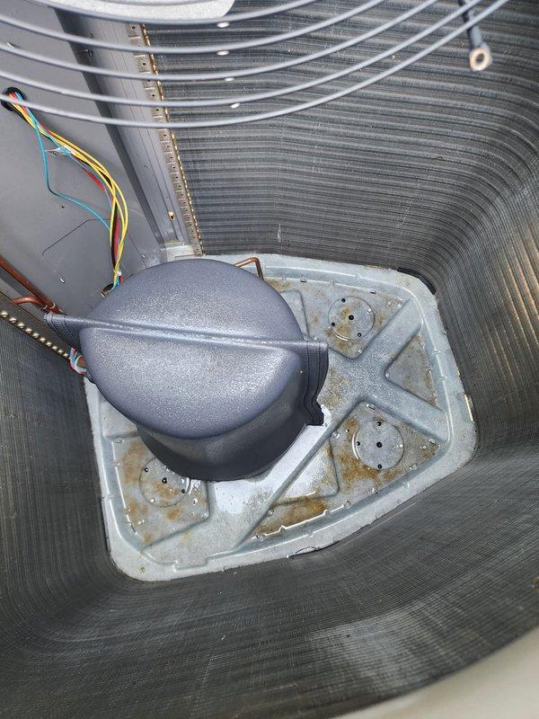 Completed comprehensive AC tune-up on 10-year-old outdoor condensing unit. Performed thorough cleaning of condenser coils, inspected compressor and fan motor operation, verified electrical connections, and cleared debris from unit exterior and surrounding area. All components operating within normal parameters; drain pan shows age-appropriate wear with minor staining but remains functional.