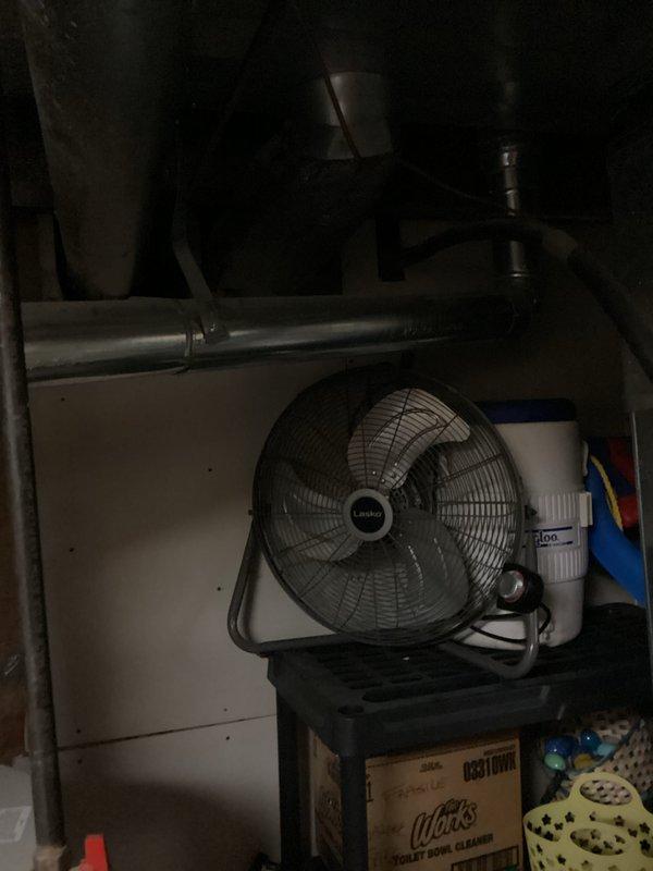 Responded to service call for water heater leaking from bottom in basement utility area. Upon arrival, conducted thorough inspection of white cylindrical residential water heater with visible copper supply lines and discharge piping. Documented existing conditions through photography showing unit positioned adjacent to HVAC equipment with metallic ductwork overhead. Visual examination revealed active leak originating from lower section of tank, indicating potential internal tank failure or deterioration of bottom drain valve assembly. Assessed surrounding area for water damage and confirmed concrete floor showed signs of moisture accumulation. Evaluated age and condition of unit based on manufacturer label and overall system configuration. Photographed installation setup including copper piping connections, pressure relief valve, and gas supply lines for estimate documentation. Provided comprehensive estimate for water heater replacement including removal of existing failed unit, prope