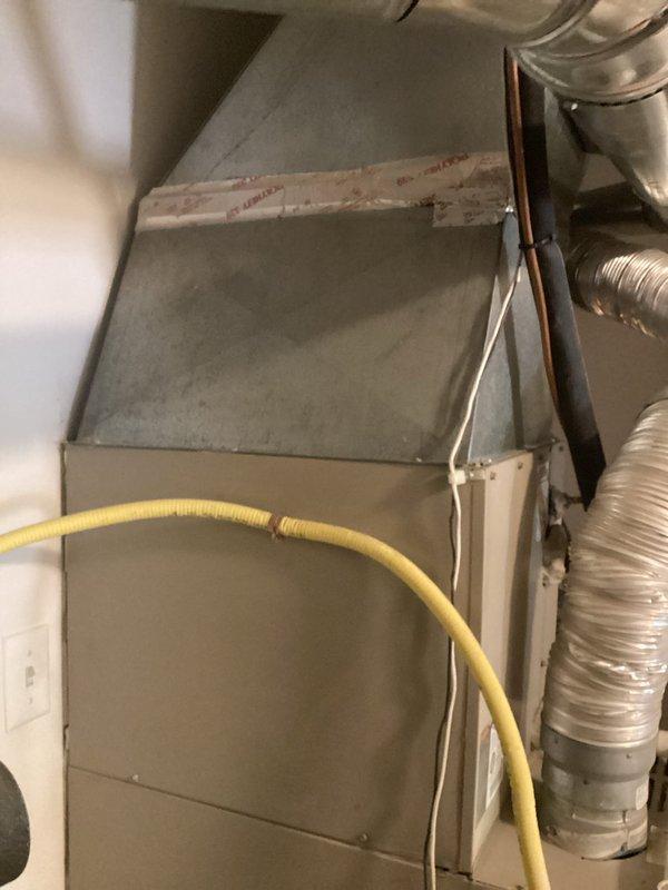 Completed estimate for full HVAC system replacement in residential utility closet. Evaluated existing aging air handler, furnace unit, flexible and rigid ductwork, refrigerant lines, gas line connections, and condensate drainage system. Documented current equipment condition showing significant wear on metal surfaces and components requiring replacement. Photographed complete installation including air handler positioning, ductwork configuration, copper refrigerant line routing, yellow gas line connections, and PVC condensate drain setup for comprehensive replacement quote preparation.