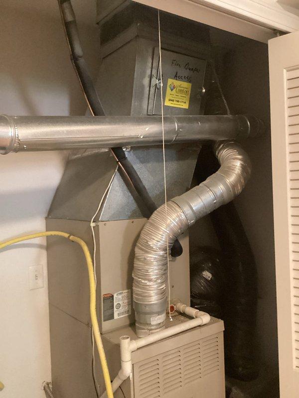 Completed estimate for full HVAC system replacement in residential utility closet. Evaluated existing aging air handler, furnace unit, flexible and rigid ductwork, refrigerant lines, gas line connections, and condensate drainage system. Documented current equipment condition showing significant wear on metal surfaces and components requiring replacement. Photographed complete installation including air handler positioning, ductwork configuration, copper refrigerant line routing, yellow gas line connections, and PVC condensate drain setup for comprehensive replacement quote preparation.