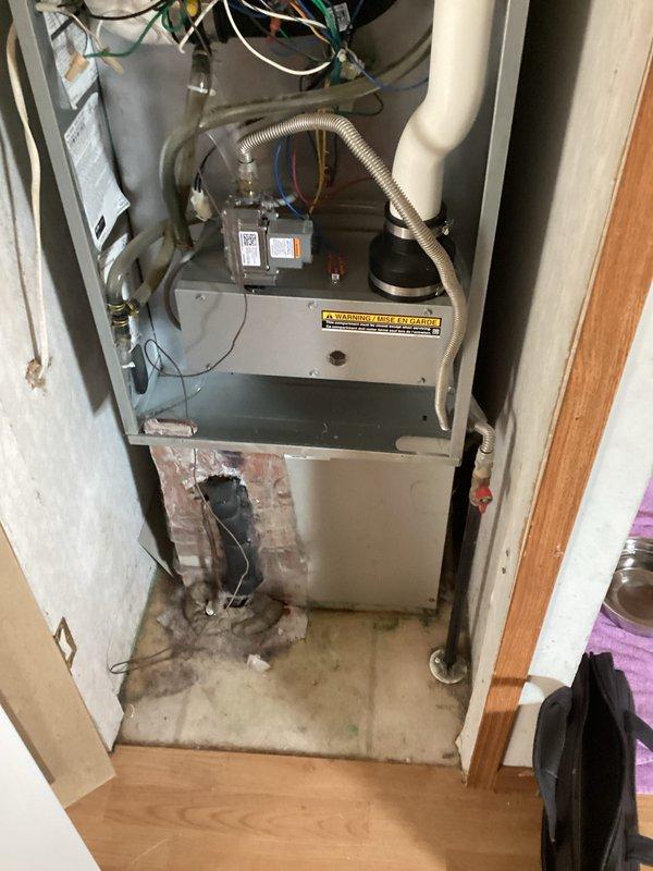 Completed estimate for air conditioning system replacement at residential property. Current unit is operational but performing poorly, with age unknown. Inspection revealed furnace installation in interior closet with visible signs of moisture damage on flooring and lower unit panels, along with water staining around base of equipment. Documented existing vertical furnace configuration with exposed wiring connections, blower assembly, and PVC condensate drainage system. Assessed utility space constraints and existing infrastructure to provide comprehensive replacement options for aging HVAC system showing deterioration from extended service life and moisture exposure.