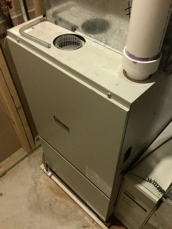 Conducted estimate for replacement of 15-year-old R22 air conditioning system experiencing refrigerant leak. Unit controls upstairs zone and has reached end of serviceable life due to age and obsolete refrigerant type. Documented existing HVAC installation including air handler, ductwork, and furnace configuration in basement utility area. Assessed current system layout and provided replacement recommendations for complete AC system upgrade to comply with current refrigerant standards.