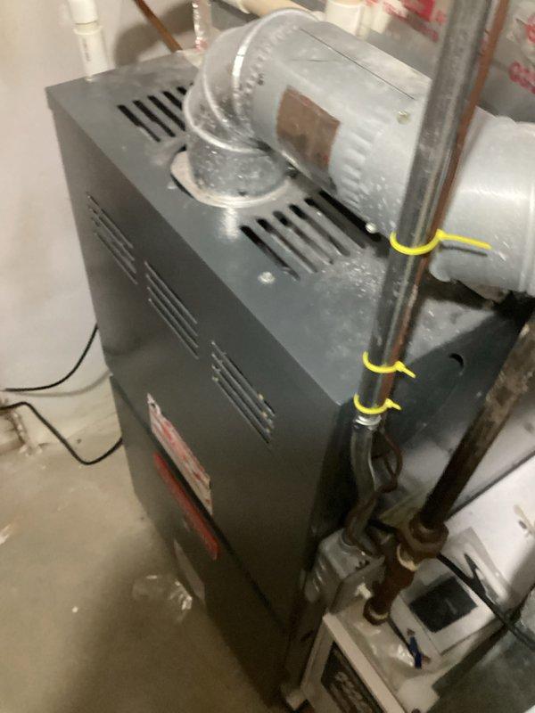 Completed on-site evaluation for replacement estimate of existing 20-year-old air conditioning unit located in backyard and 15-year-old furnace in basement. Documented current system configuration including existing humidifier installation, copper refrigerant line routing with support brackets, PVC condensate drainage, and ductwork connections. Photographed equipment specifications, model information, and mechanical room layout to provide accurate replacement system sizing and installation scope. Customer requested humidifier inclusion with new furnace installation; both existing systems currently operational with no reported performance issues.