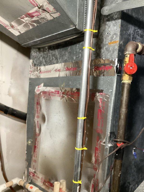 Completed on-site evaluation for replacement estimate of existing 20-year-old air conditioning unit located in backyard and 15-year-old furnace in basement. Documented current system configuration including existing humidifier installation, copper refrigerant line routing with support brackets, PVC condensate drainage, and ductwork connections. Photographed equipment specifications, model information, and mechanical room layout to provide accurate replacement system sizing and installation scope. Customer requested humidifier inclusion with new furnace installation; both existing systems currently operational with no reported performance issues.