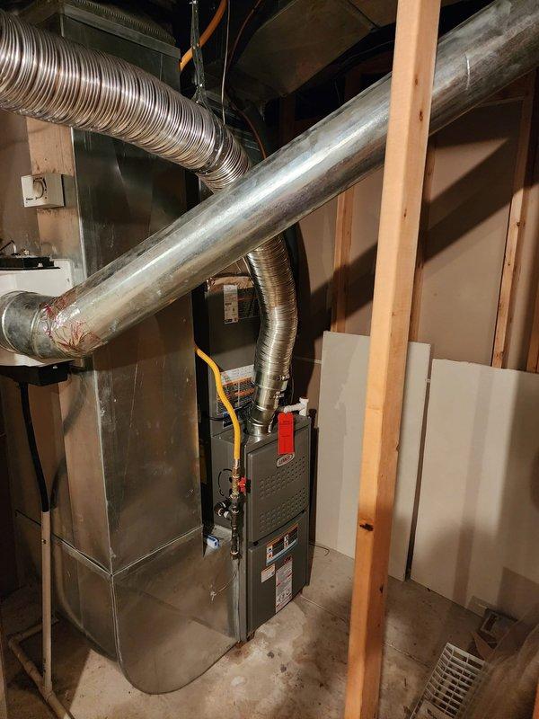 Completed full HVAC system installation including Lennox 80% efficiency gas furnace, central air conditioning unit, and T6 programmable thermostat in residential basement mechanical room. Installation included all necessary ductwork connections, electrical wiring, gas line hookup, condensate drain lines, and refrigerant line sets between indoor and outdoor components. System was tested for proper operation, airflow verified, thermostat programmed and calibrated, with all components functioning within manufacturer specifications upon completion.