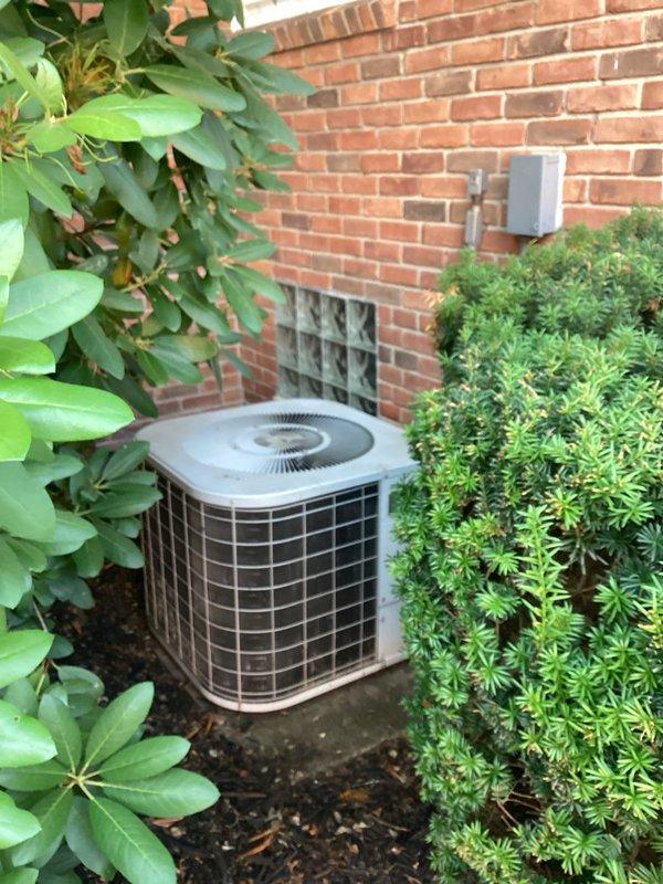 Conducted comprehensive assessment of non-functional air conditioning system and existing furnace installation located in basement utility area. Evaluated outdoor condenser unit positioned against exterior brick wall, documented current equipment configuration including ductwork, condensate drainage system, and electrical connections, and provided complete system replacement estimate for new HVAC equipment.