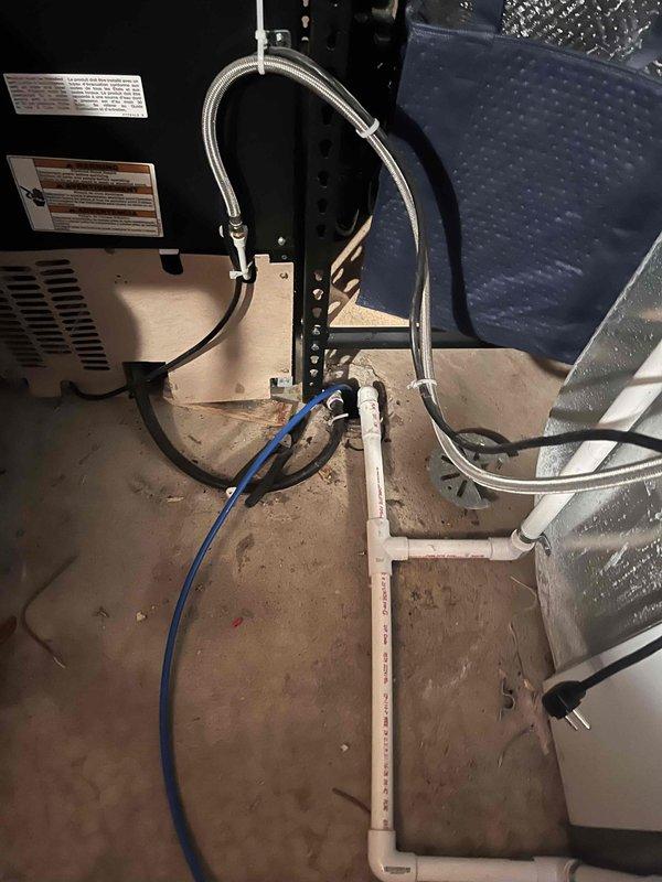 Completed full HVAC system installation including Lennox furnace and air conditioning unit with associated venting and drainage systems. Installed S40 thermostat for primary system and Ecobee thermostat for lower zone system to provide dual-zone climate control capability.

The installation involved mounting the new Lennox furnace in the basement mechanical room with proper clearances and securing all supply and return ductwork connections. Ran white PVC exhaust and intake venting through the structure per manufacturer specifications for high-efficiency condensing operation. Connected condensate drainage line with appropriate trap and routing to approved drain location. Integrated black flexible ductwork to existing distribution system and verified proper airflow. Completed all electrical connections including dedicated circuits and low-voltage control wiring.

Installed outdoor condensing unit with refrigerant line set connections, ensuring proper brazing techniques and leak-free join
