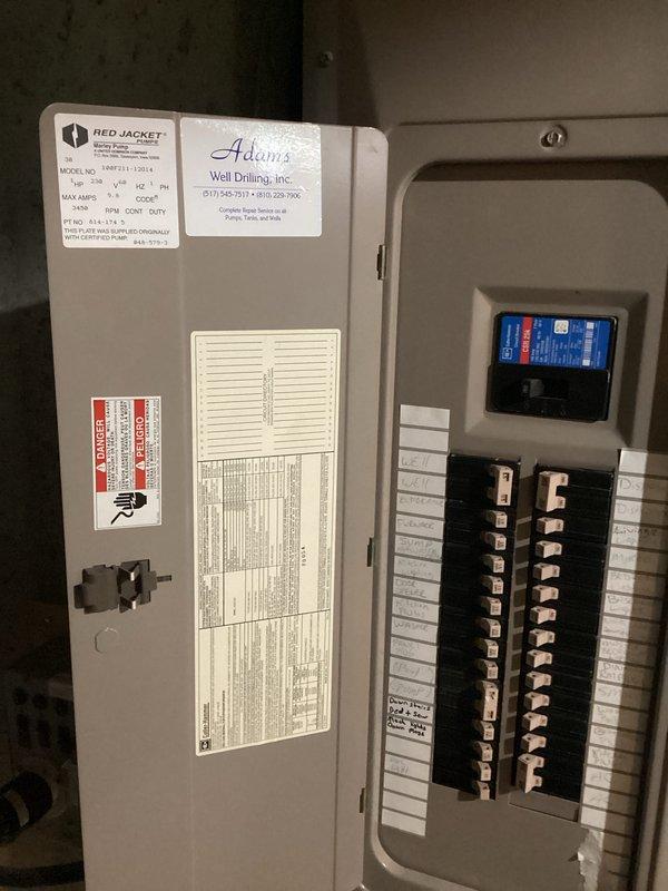 Conducted comprehensive electrical assessment for generator integration at residential property. Documented existing 200-amp main service panel configuration, circuit breaker layout, and current electrical distribution system serving well pump, HVAC equipment, refrigeration, and sump pump circuits. Photographed panel directory labeling, breaker positions, and available capacity for determining optimal generator transfer switch installation location and required electrical modifications to accommodate automatic standby generator system.